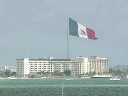 WS View of Very large Mexican national flag flying in Cancun hotel zone, viewed from acrossshore/ Cancun, Quintana Roo, Mexico Stock Footage