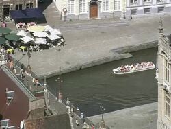MS AERIAL ZI Tourist roaming with canal boats in city / Flanders, Belgium Stock Footage