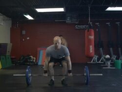 Medium shot. Dustin performs series of thrusters. Stock Footage