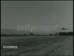1942: U.S. AIR SQUADRON: LANDING: WS Naval Air Force grounds man signaling on airfield, fighter airplane landing. WS Airplane (variation of Curtiss P-36 Hawk) landing on strip. MS Signal man directing airplane flight path, plane landing BG. Instructional Video