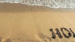 HOLIDAYS written in sand Stock Footage