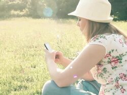 girl in nature texting message on the phone Stock Footage