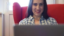 smiley young woman working with laptop at home Stock Footage