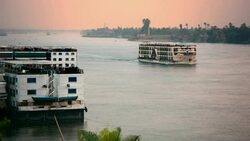 Nile River cruise ship at sunset near Luxor Egypt Stock Footage