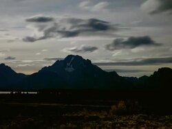 WS T/L View of dark clouds and shadows move thru starry night sky passing over mountains at Grand Teton National Park / Jackson Hole, Wyoming, United States Stock Footage