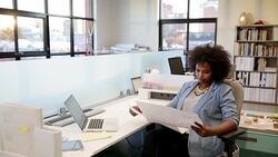 Architect reviewing blueprints at desk in office Stock Footage