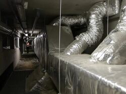 Woman lost in the underground of a technical plant Stock Footage