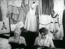 B/W 1934 2 senior women sewing in WPA garment factory / documentary Stock Footage