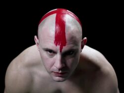 Man with red cross painted on his head looking at camera Stock Footage