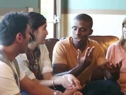 Young man and woman explaining something to group of friends Stock Footage