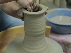 Shot of holding clay and making pottery shape with hands and pottery wheel Stock Footage