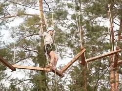 Girl on High Wires Ropes course Stock Footage