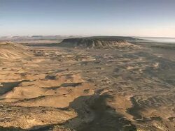 Wide Shot pan-right - Rugged hills stretch across a vast desert / Sahara, Egypt Stock Footage