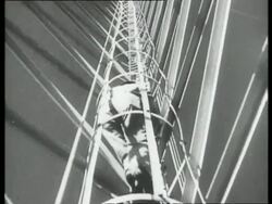 Electricity pylons built of steel; man on ladder, UK 1939 Stock Footage