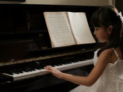 MS Rear view of girl wearing white dress, playing piano / China Stock Footage