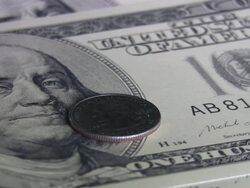 Quarter coin spinning over hundred dollars bill. Currency. Finance. Money. Stock Footage