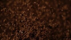 Instant coffee pieces falling and hitting ground Stock Footage