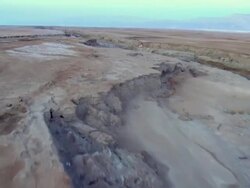 AERIAlL WS TS View of muddy surface of dead sea in desert / Sourn Judea Desert, Israel  Stock Footage