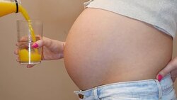 filling pregnant woman's glass with juice Stock Footage