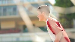 Goalie bounces on his feet and dives to block shot in youth soccer match Stock Footage