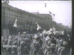 1942: JAPAN: IMPERIAL JAPANESE ARMY: * WS IJA soldiers marching during rally on streets. WS DRIVING Past crowds of Japanese waving Japan flag. VS More troops marching through parade, group of soldiers holding up Rising Sun Flags. WWII, World War II Instructional Video