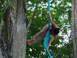MS TD Woman hangs and spinning and dances upside down hangs from material in trees in tropical environment / Montezuma, Puntarenas, Costa Rica Stock Footage