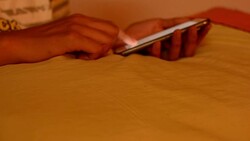 young woman using smart phone on the bed Stock Footage