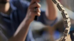 Young craftsman chisels flexible chair frame in wood shop Stock Footage