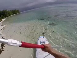 POV of a man stand-up paddle boarding in the lagoon around Bora Bora island in French Polynesia. - Slow Motion Stock Footage