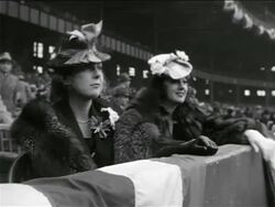 B/W 1939 two women (one is Mrs. Gehrig) in furs + hats sitting in stadium / Lou Gehrig's farewell Stock Footage