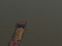 Aerial view of cargo barge sailing along river, China Stock Footage