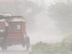 Rain and wind from typhoon Megi or Juan batter motorbike taxi in the Philippines. Super Typhoon Megi or Juan, NE Luzon, Philippines Oct 2010 / AUDIO Stock Footage
