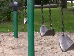 Empty swings in a playground Stock Footage