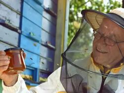 HD Super Slow-Mo: Beekeeper Holding A Glass Of Honey Stock Footage