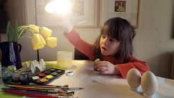 Learning Process-Little girl painting Easter eggs at home Stock Footage