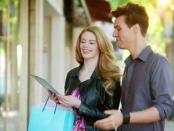 Couple window shopping with a tablet Stock Footage