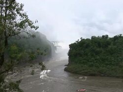 WS View of boat moving near waterfall / IguazÃƒÂº waterfall, ParanÃƒÂ¡, Brasil Stock Footage