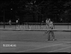 1947: CLEVELAND RECREATION: VS Adults playing tennis on tennis court. VS People sailing in sail boats on Lake Erie, three males steering boat. VS Fishermen sitting along shorefront fishing, young boy tossing fishing line, fishing rod. OH, relaxation Instructional Video