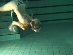 Blond girl swimming underwater Stock Footage