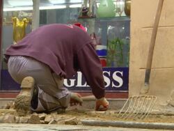 MS Shot of man working and placing stone at road Stock Footage