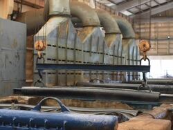 Steel Mill - Coils lifted from bath Stock Footage