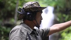 Researchers listen to the radio signal from radio telemetry,tracking to find an wildlife in tropical rainforest Stock Footage