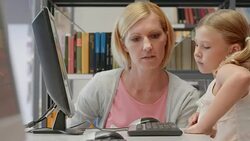 DS Woman and girl browsing on computer in library Stock Footage