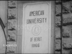 1952: BEIRUT, LEBANON: Angled WS American University of Beirut w/ cars moving through FG. MS 'American University of Beirut 1866' building plaque, VS Male college students in class, measuring parts, using slide rule.           [VO Dr Charles Malik] Instructional Video
