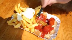 Eating french fries with currywurst Stock Footage