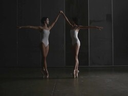 Two ballerinas performing penchÃƒÂ© on point Stock Footage