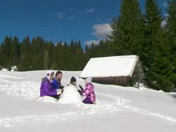 HD CRANE: Family Building A Snowman Stock Footage