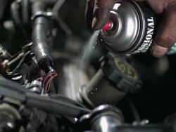 CU SLO MO Mechanics spraying cleaner on engine / Bergenfield, , New Jersey, USA Stock Footage