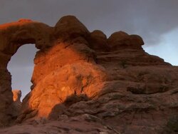 Turret Arch with dramatic morning sunshine and shadows across it's face - pan Stock Footage