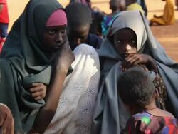 Refugee family sitting and waiting Stock Footage